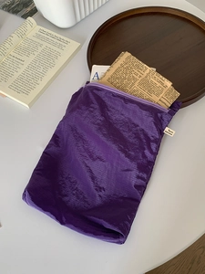 Close-up of purple ultra-light storage bag with nylon grid texture and zipper closure