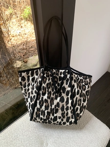 Close-up of diamond quilted leopard print tote bag with durable black webbing handles