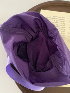 Macro shot of purple travel organizer bag fabric texture and spacious interior detail