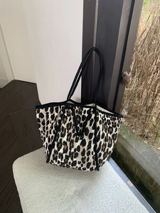 Detail view of the quilted leopard print tote bag with black straps and large capacity