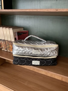 Detailed heart-quilted travel organizer bags in silver and black with top handles