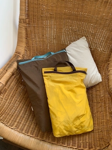 Close-up of lightweight nylon travel storage bags with zippers and portable handles