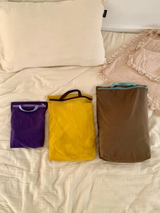 Three colorful lightweight travel storage bags with zipper closure and carry handles