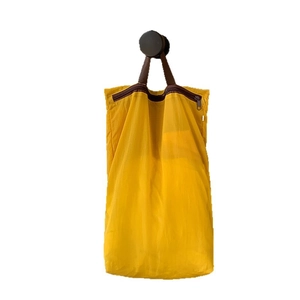 Bright yellow lightweight travel storage bag with handle and zipper on white background