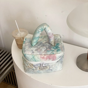 Quilted floral makeup bag with macaron tie-dye pattern and sturdy handle for storage