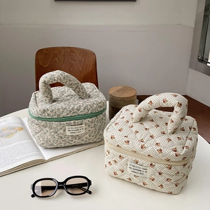 Quilted floral makeup bag with handles in green and pink prints for toiletries