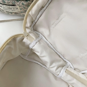 Close-up of the quilted makeup bag interior showing neat stitching and durable zipper