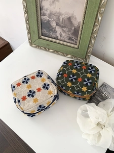 Detailed close-up of floral embroidery on cotton-linen makeup pouches with zippers