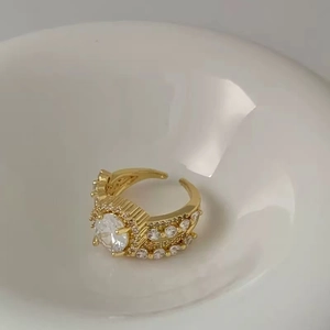 Luxurious adjustable gold open ring with a large oval zircon and micro-pave crystals