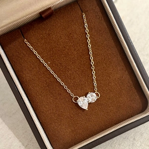 Elegant gold chain necklace with pear and round cubic zirconia in a premium jewelry box