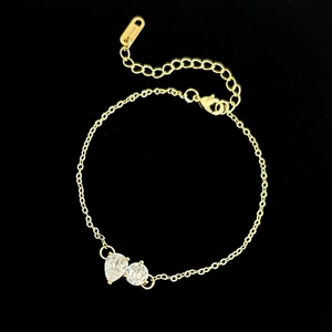 Close-up of gold chain bracelet with pear-shaped and round white cubic zirconia stones