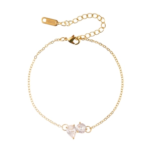Elegant gold bracelet with pear and round cubic zirconia drop charms on white background