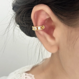 Elegant gold zircon ear cuff with milgrain edge on ear, stylish non-pierced earring