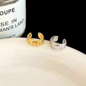 Minimalist gold and silver C-shaped ear cuffs set with vertical stripe textured metal finish