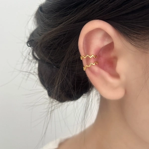 Minimalist gold wavy ear cuffs with geometric wave design for a layered fashion look