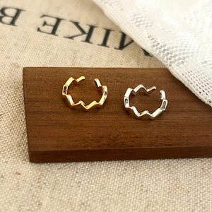 Minimalist geometric wave ear cuff set in polished gold and silver metal finishes