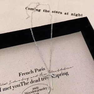 Elegant silver bow pendant necklace with sparkling zircons on vintage poetry display card