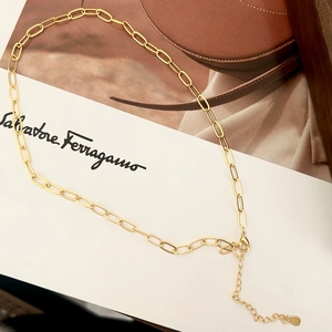 Detail of adjustable gold paperclip chain necklace with lobster clasp and extension