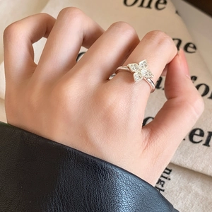 Elegant silver clover open ring with clear zircon inlay worn on index finger