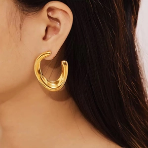 Minimalist chunky C-shaped gold hoop earrings with a polished mirror finish for women
