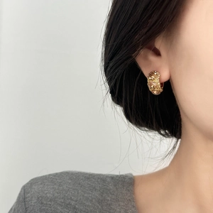 Elegant gold earrings featuring large champagne zirconia stones and pavé diamonds