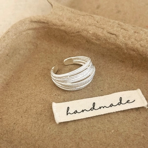 Macro shot of silver textured layered metal ring with handmade artisan craftsmanship