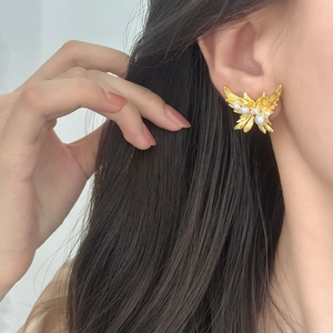 Elegant gold butterfly wing stud earrings with white pearls and sparkling zircons