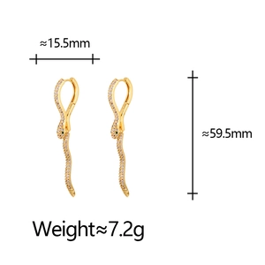Vintage long snake drop earrings with white zircons and green gem eyes on white background