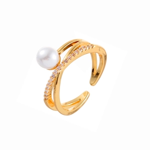 Elegant gold-tone criss-cross open ring featuring a white pearl and sparkling zircon pavé