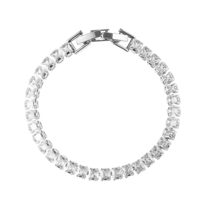 Macro view of silver tennis bracelet with emerald-cut zircons and secure folding clasp