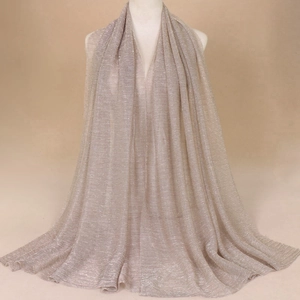Light gold shimmer shawl with pleated texture for elegant evening wear on a mannequin