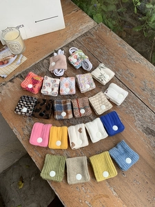 Macro view of fabric cable organizer buttons in assorted patterns on a wooden desk