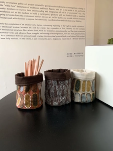 Dettaglio di portapenne in lino ricamato bohémien con texture floreale 3D da tavolo