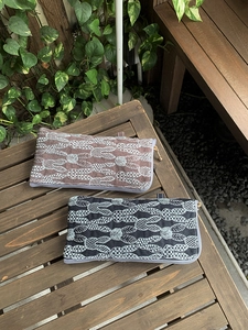Detailed view of vintage rabbit embroidery on linen pouches with metal zippers