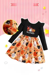 Detail of girls' Halloween dress with orange pumpkin prints and ruffled sleeves