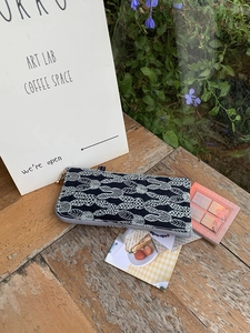 Navy blue linen eyewear pouch with white leaf embroidery and gold bead zipper pull