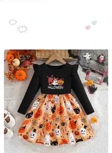 Detail of girls Halloween dress featuring pumpkin prints and a ghost pattern on black bodice