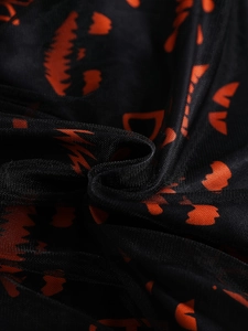 Toddler girls Halloween dress featuring orange pumpkin faces on black mesh tulle fabric
