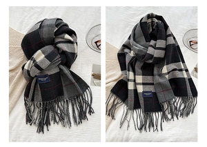 Detailed view of Elegant Classic label on a warm plaid scarf with soft fringe edges