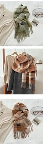 Detail of plaid cashmere-like scarves with fringe and Elegante Classic label