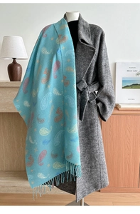 Close-up of light blue paisley scarf with pleated texture and tassel fringe detail