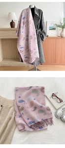 Detail of pink paisley knit scarf with fringe texture and trendy winter patterns