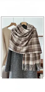 Detail of coffee and beige plaid scarf showing soft texture and fringed edges