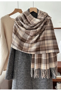 Detail of brown plaid scarf with tassels styled over a gray wool coat for winter