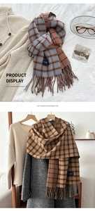 Detail of plaid imitation cashmere scarf with tassel edges and premium fabric texture