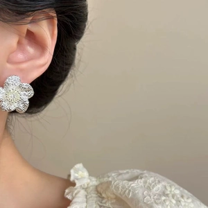 French vintage hammered silver flower stud earrings with zircon center on model