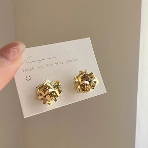 Irregular geometric gold earrings with architectural 3D stacked structure design