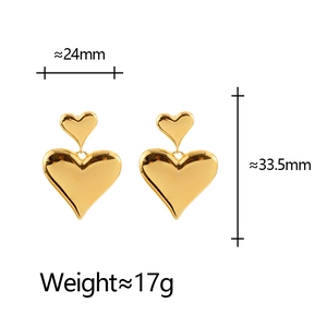 Detail view of 3D gold heart earrings with 24mm width and 33.5mm height dimensions