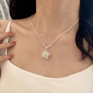 Minimalist silver fireworks pendant necklace with sparkling cubic zirconia on a female model