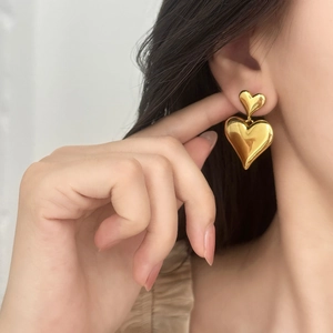 Elegant gold double heart stud earrings with mirror finish for a minimalist feminine look